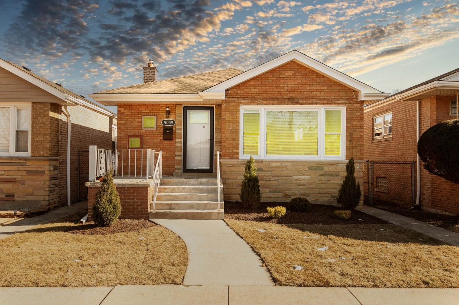 Sold home at 9009 S Phillips Ave, Chicago, a brick and limestone bungalow with a bay window and front steps