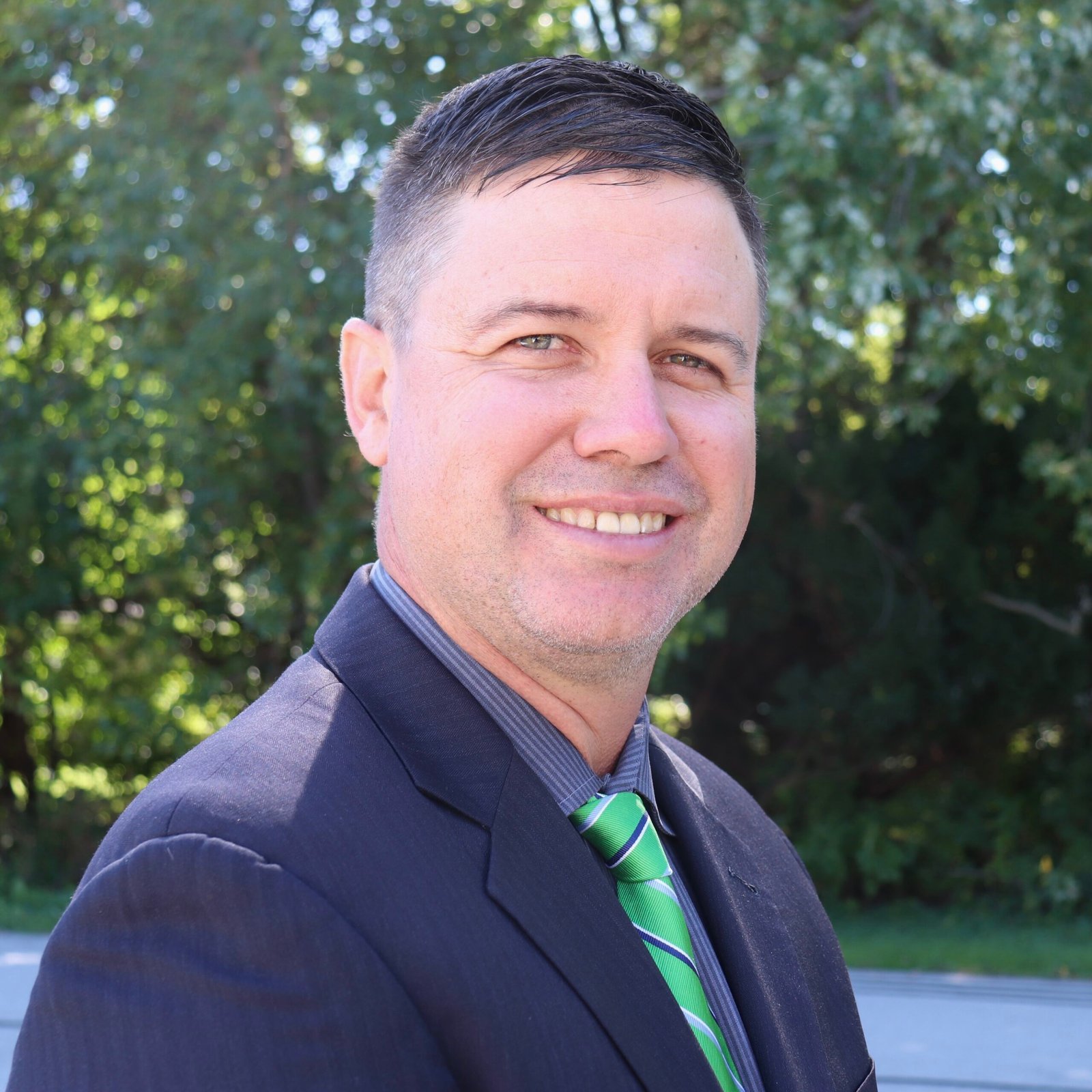 Matthew Gallagher, Chicago South Side Realtor, smiling in a navy suit